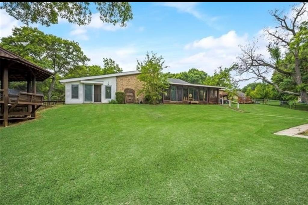 6049 West Red Bird Lane Dallas, TX 75236 - Photo 34 of 34 a view of a house with a yard