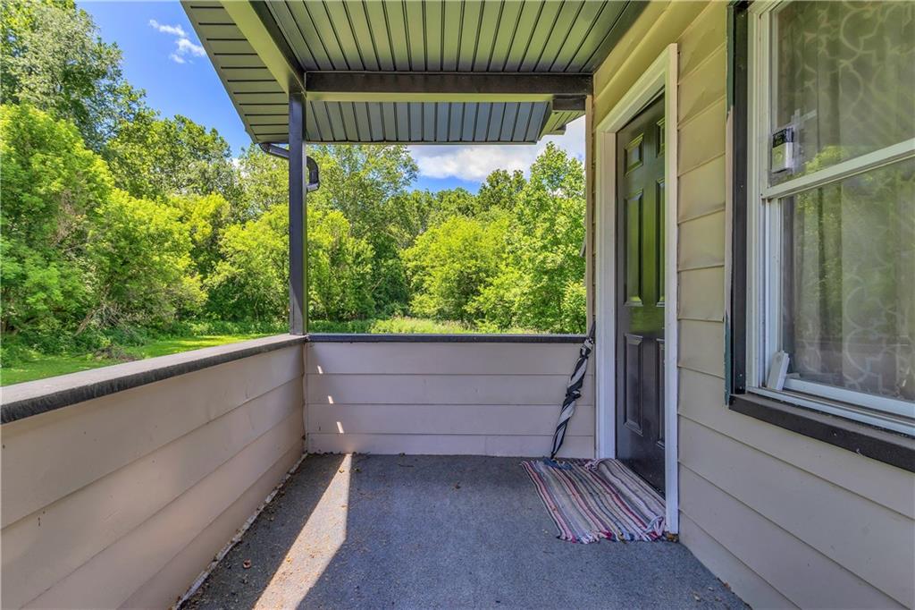 1747 Galilee Road Wampum, PA 16157 - Photo 21 of 32 The deck offers a relaxing outdoor escape overlooking the home’s peaceful, tree-lined surroundings.