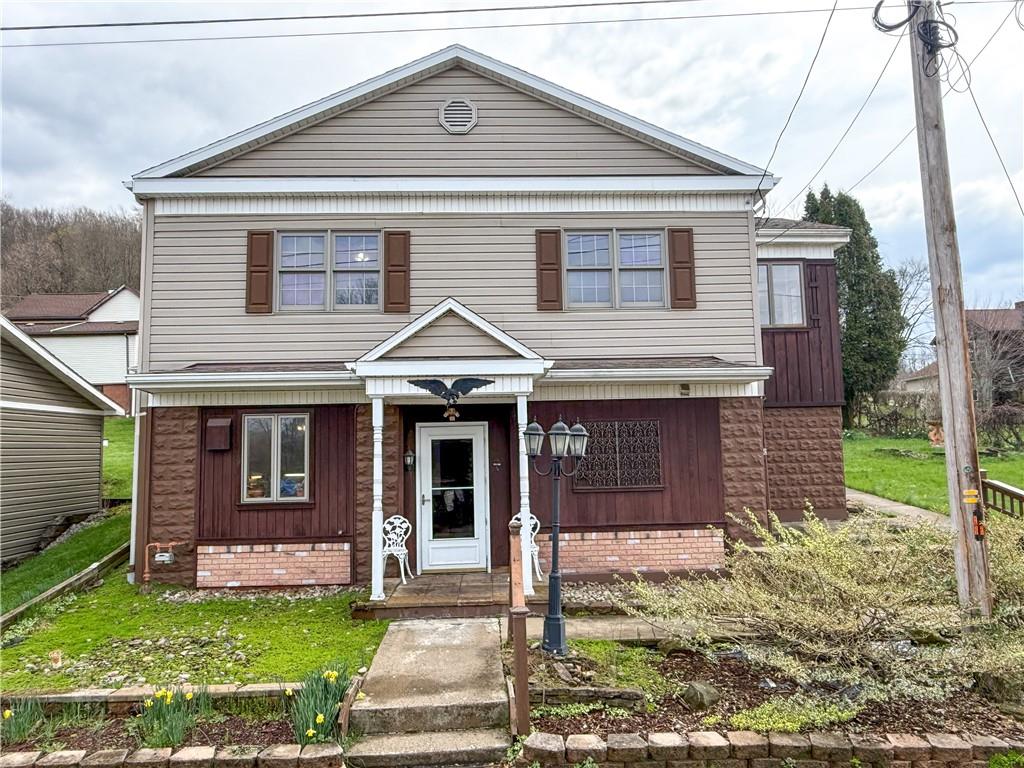 a front view of a house with a yard