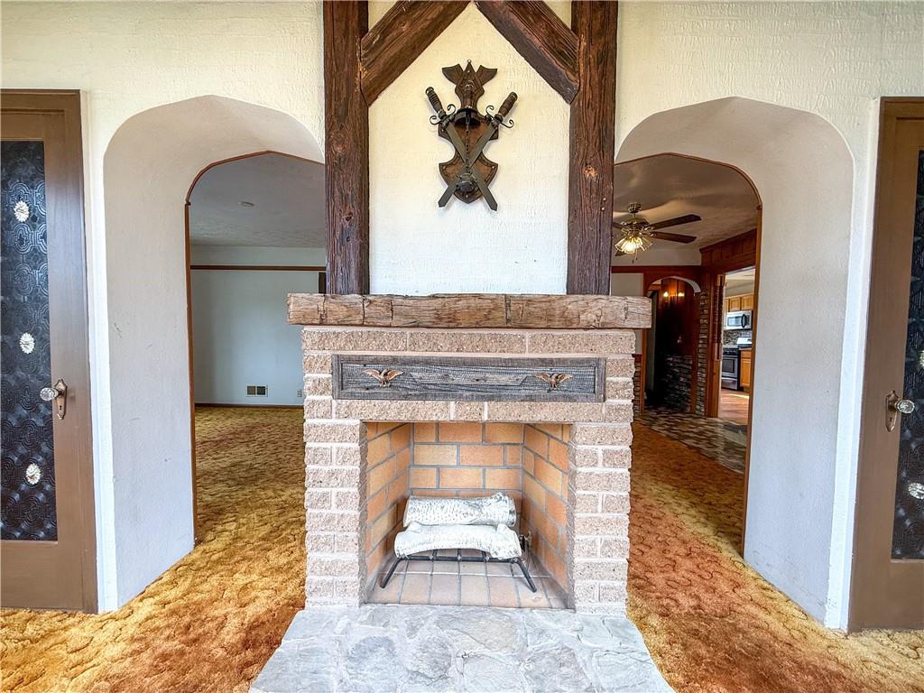 122 Lower Troy Hill Road Kittanning, PA 16201 - Photo 13 of 42 a living room with a fireplace and a painting on the wall