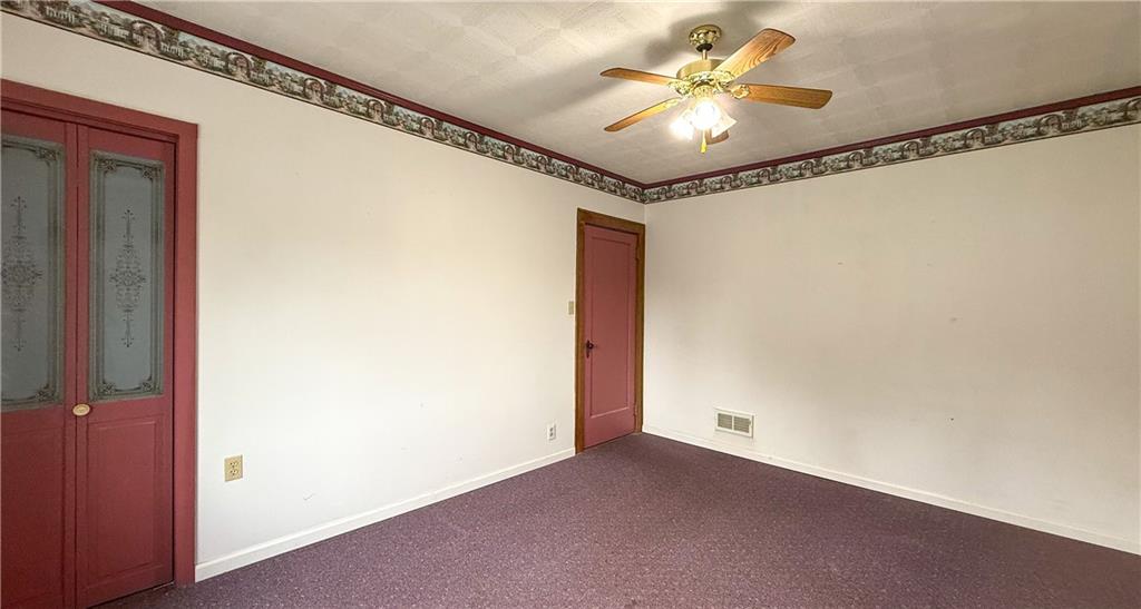 122 Lower Troy Hill Road Kittanning, PA 16201 - Photo 18 of 42 a view of a livingroom with a ceiling fan and carpet