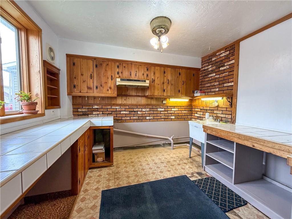 122 Lower Troy Hill Road Kittanning, PA 16201 - Photo 32 of 42 a kitchen with stainless steel appliances kitchen island granite countertop a sink and cabinets
