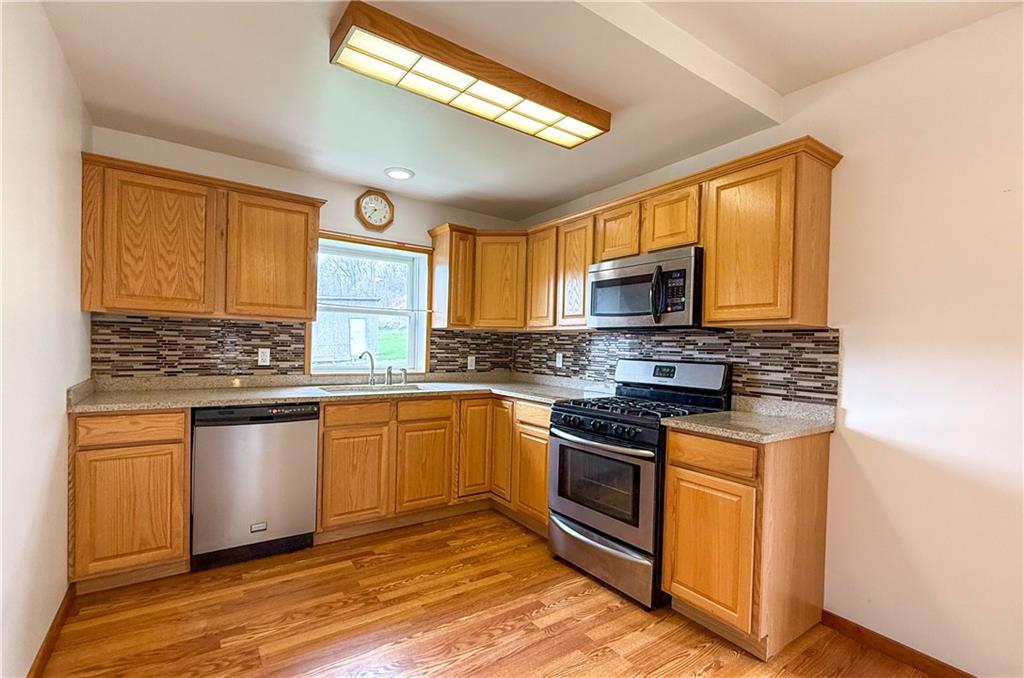 122 Lower Troy Hill Road Kittanning, PA 16201 - Photo 5 of 42 a kitchen with stainless steel appliances granite countertop a stove and a sink