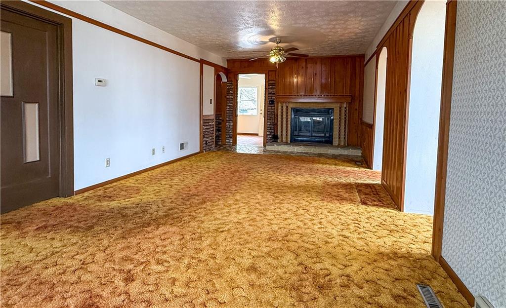 122 Lower Troy Hill Road Kittanning, PA 16201 - Photo 9 of 42 a view of empty room with wooden floor and fireplace