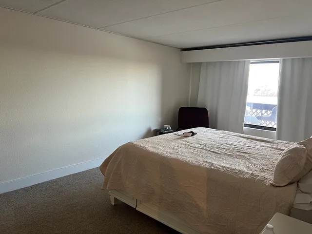 a bedroom with a bed and window