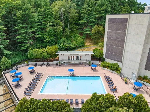swimming pool view with a seating space