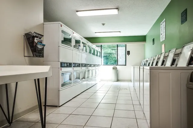 a large white room with a large mirror and sink