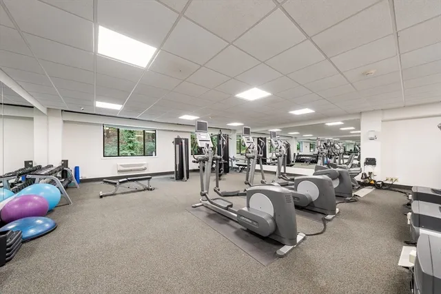 a living room with lots of furniture and a large window