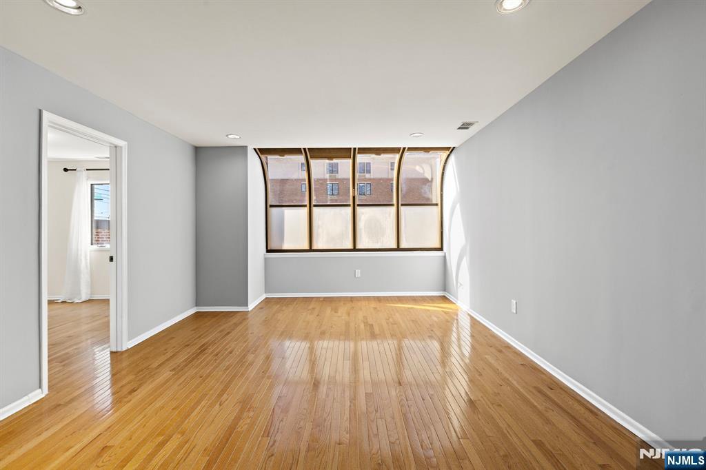 319 Gorge Road, Unit 6 Cliffside Park, NJ 07010 - Photo 5 of 24 wooden floor in an empty room with a window
