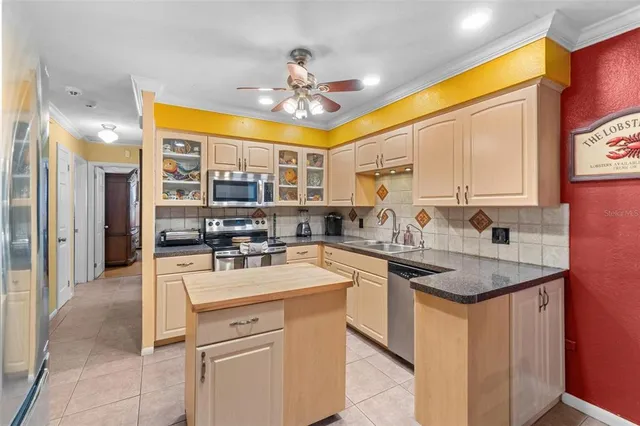 a kitchen with a sink stove and cabinets