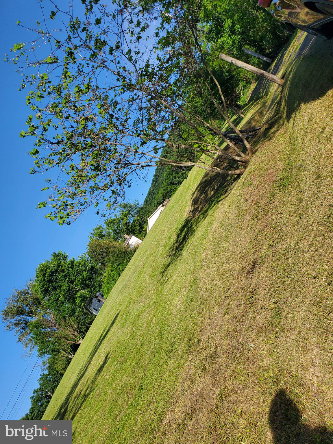 7881 Ford Hill Road Rio, WV 26755 - Photo 27 of 27 Lush green landscape under clear skies.