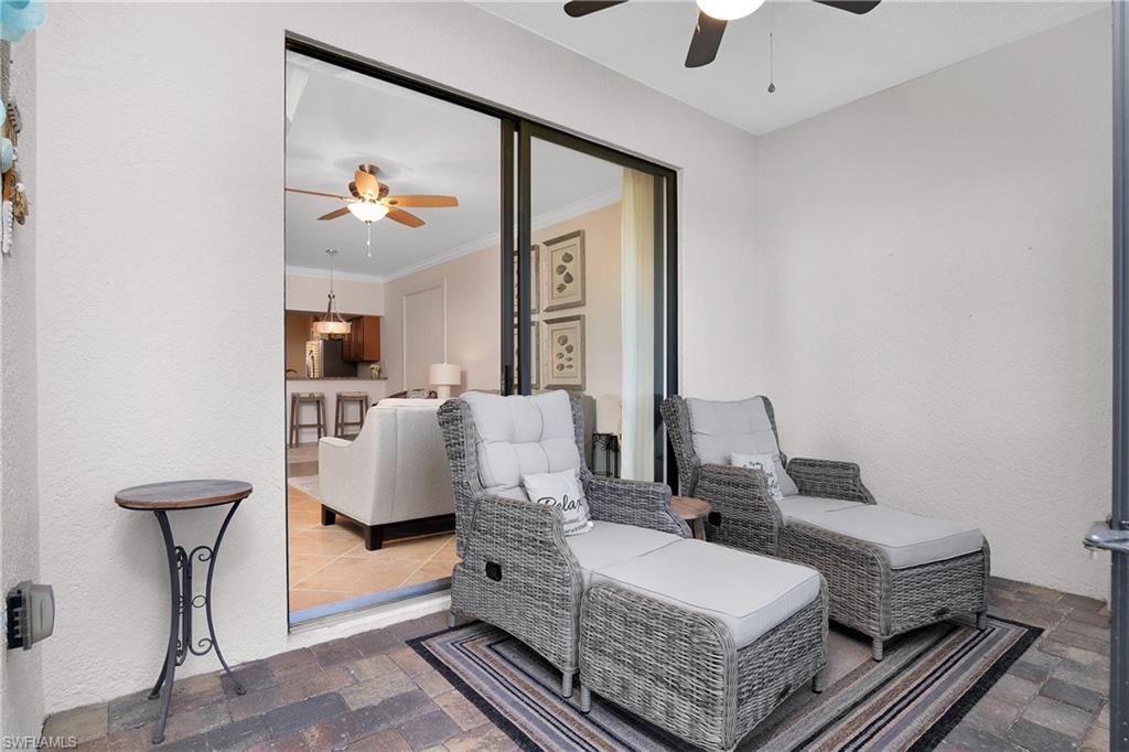 9719 Acqua Court, Unit 214 Naples, FL 34113 - Photo 10 of 50 a living room with furniture and a chandelier