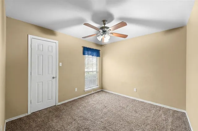 a bed room with a bed and a ceiling fan