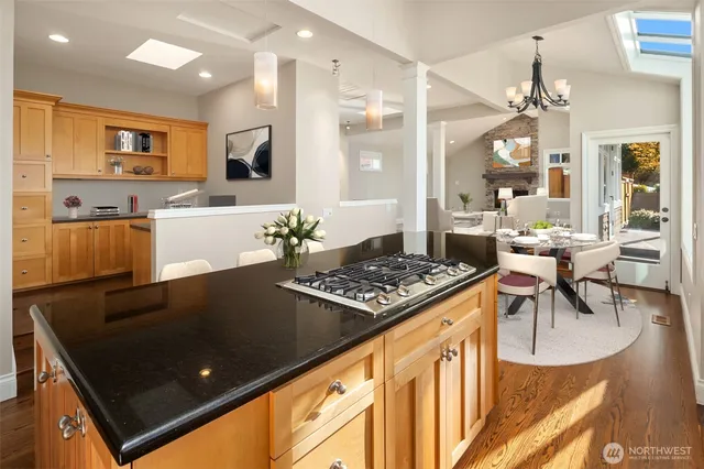 a kitchen with stainless steel appliances granite countertop a stove a sink and a refrigerator