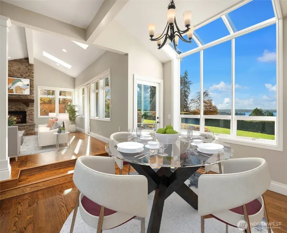 a dining room with furniture window and wooden floor