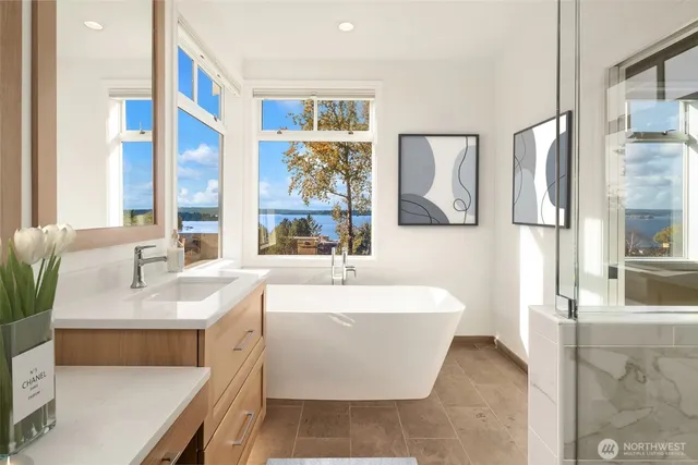 a bathroom with a tub sink and mirror