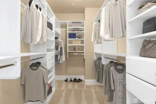 a view of walk in closet with clothes and shoes