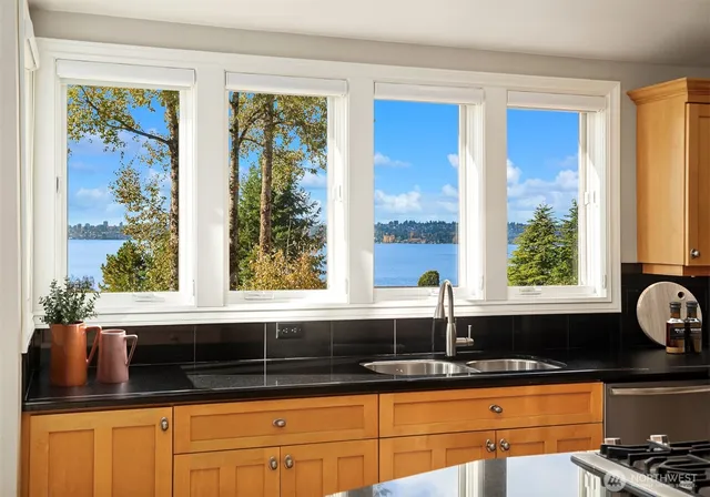a kitchen with granite countertop a sink and a window