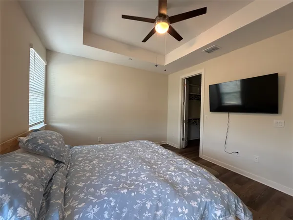 a bedroom with a bed and a flat screen tv