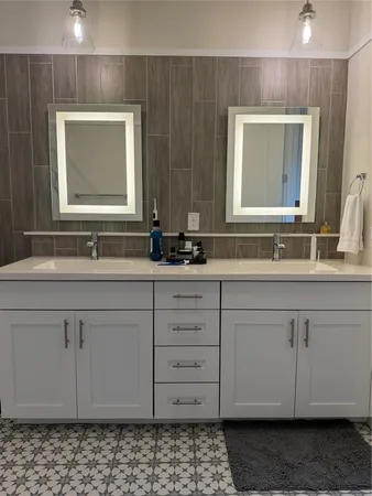 a bathroom with a sink vanity and mirror