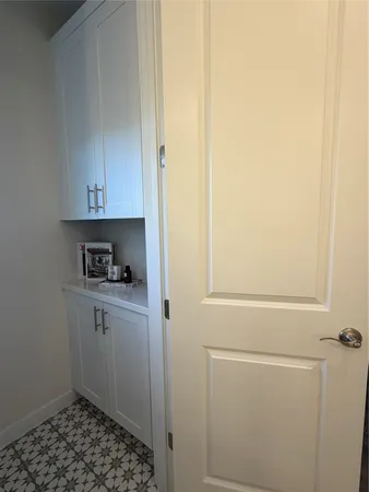 a kitchen with a refrigerator and cabinets