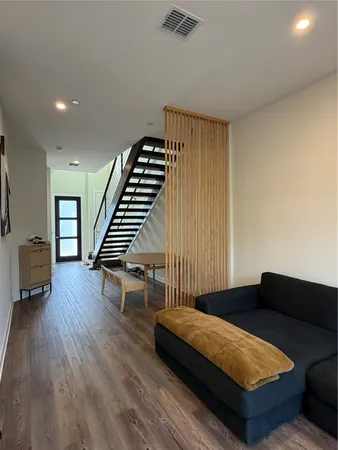 a bedroom with furniture and wooden floor
