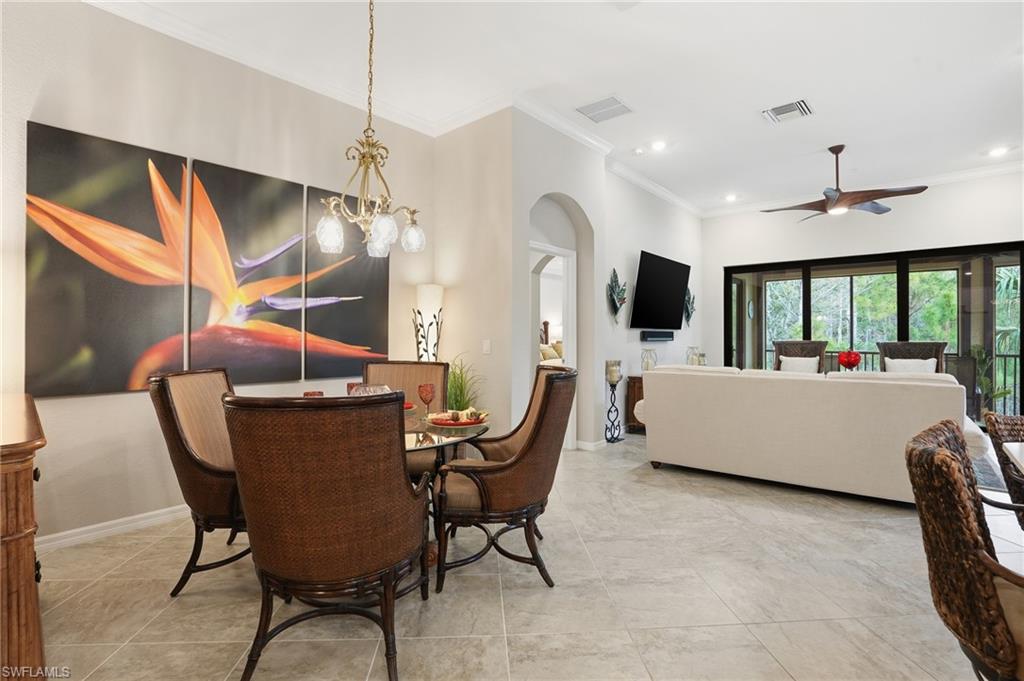 10505 Casella Way, Unit 202 Fort Myers, FL 33913 - Photo 14 of 50 a living room with furniture a chandelier and a flat screen tv