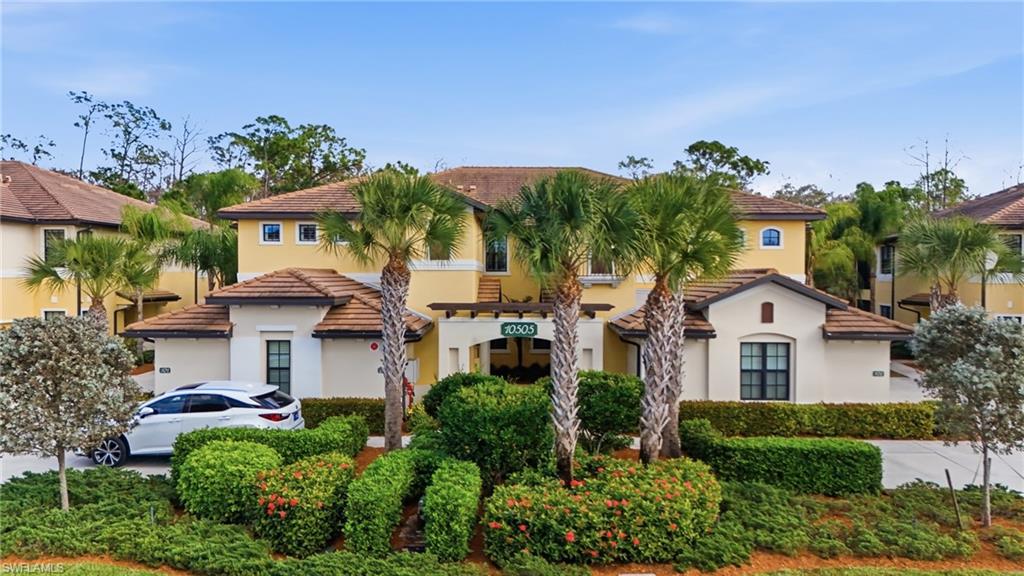 10505 Casella Way, Unit 202 Fort Myers, FL 33913 - Photo 2 of 50 a front view of a house with a garden
