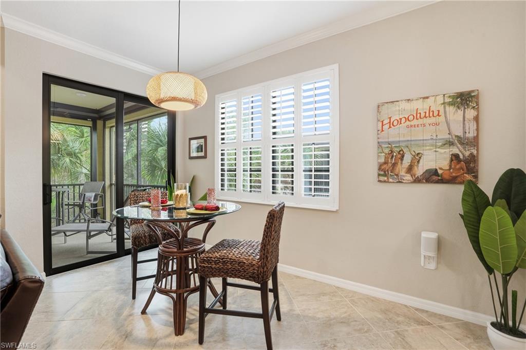 10505 Casella Way, Unit 202 Fort Myers, FL 33913 - Photo 21 of 50 a dining room with furniture a chandelier and wooden floor