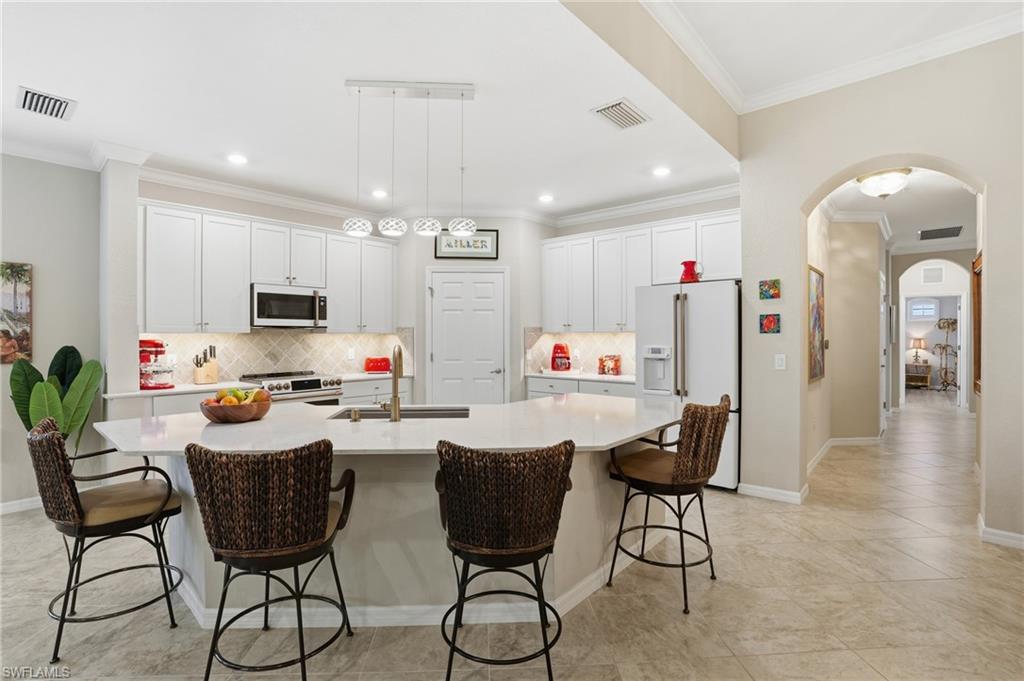 10505 Casella Way, Unit 202 Fort Myers, FL 33913 - Photo 24 of 50 a view of a dining room with furniture and wooden floor