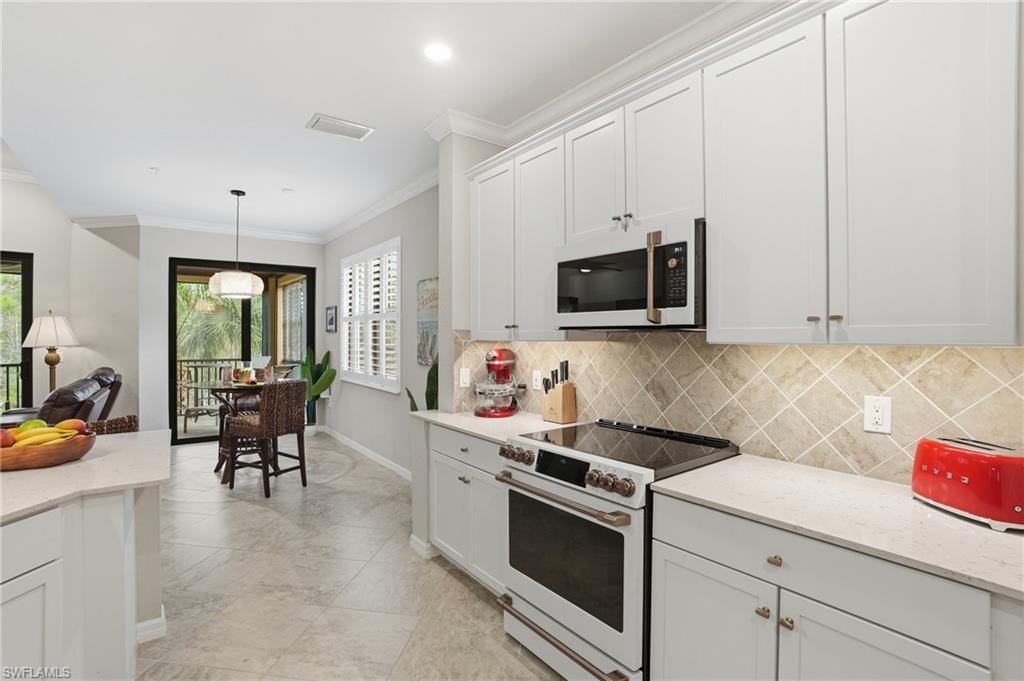 10505 Casella Way, Unit 202 Fort Myers, FL 33913 - Photo 27 of 50 a kitchen with a stove and a white cabinets