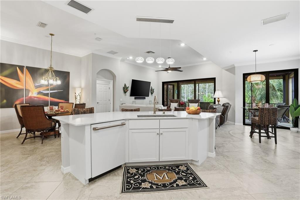 10505 Casella Way, Unit 202 Fort Myers, FL 33913 - Photo 28 of 50 a kitchen with a sink dining table and chairs