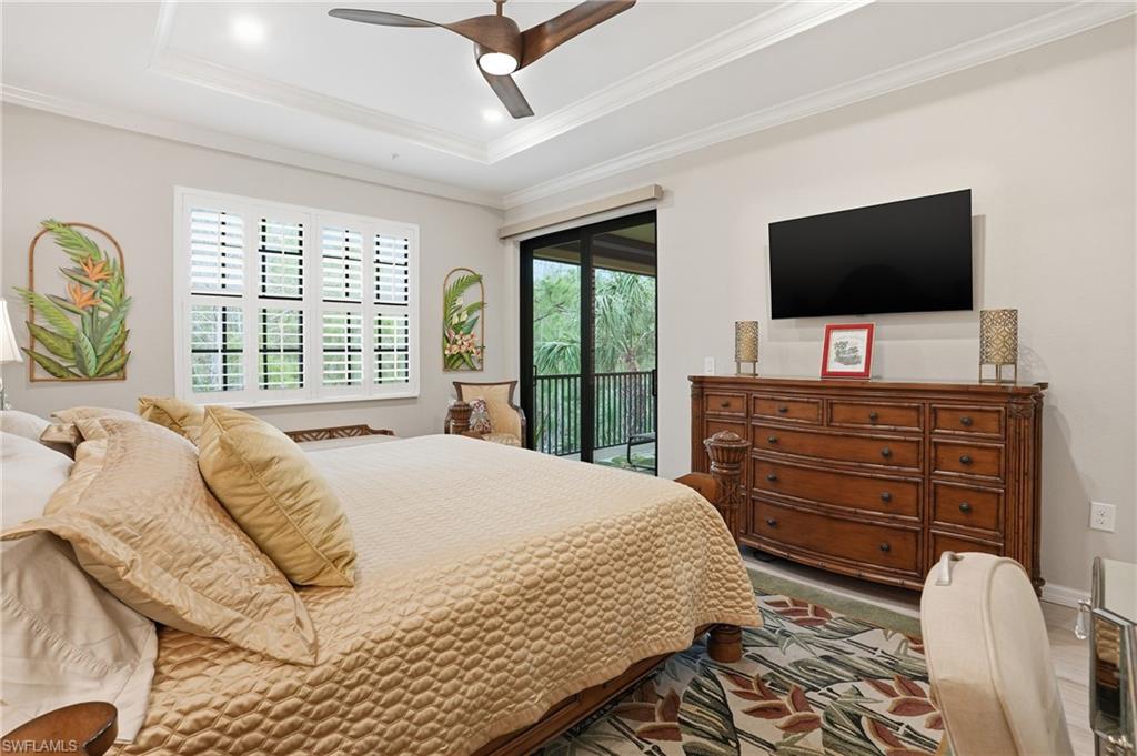 10505 Casella Way, Unit 202 Fort Myers, FL 33913 - Photo 32 of 50 a bedroom with a bed and a flat screen tv on dresser