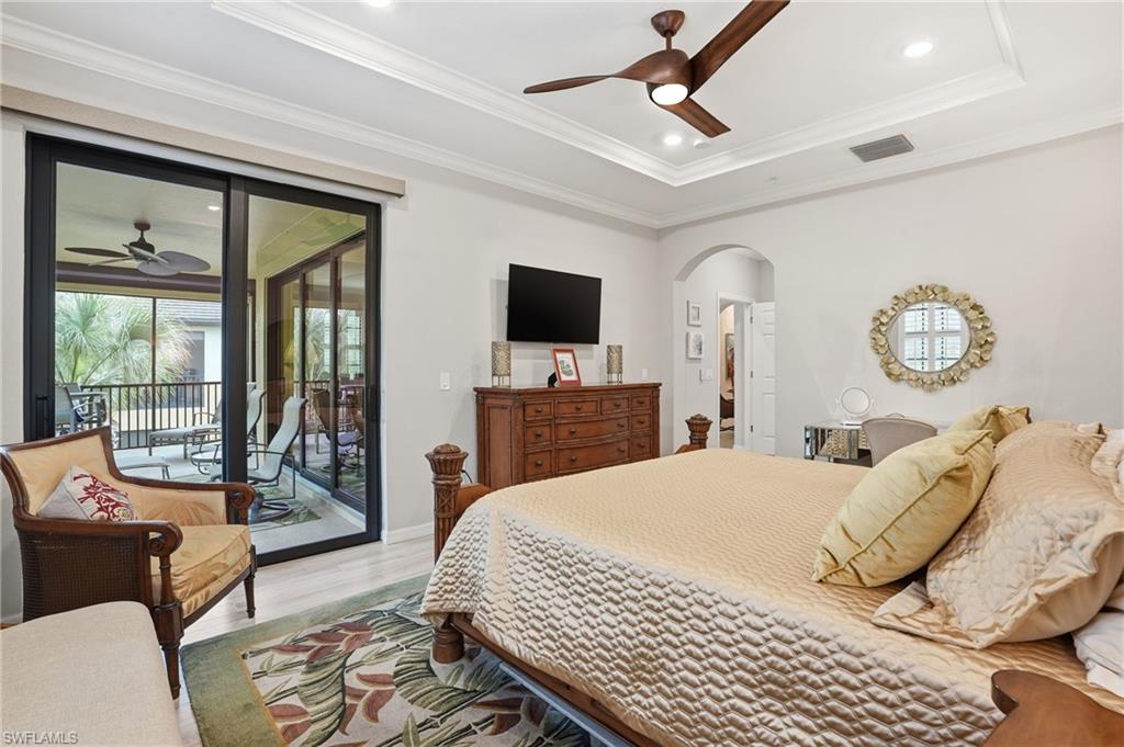 10505 Casella Way, Unit 202 Fort Myers, FL 33913 - Photo 33 of 50 a bedroom with a bed and glass door