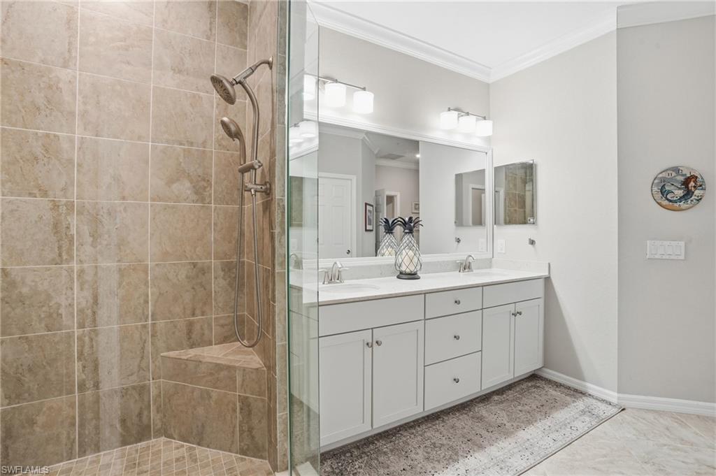 10505 Casella Way, Unit 202 Fort Myers, FL 33913 - Photo 35 of 50 a bathroom with a double vanity sink a mirror and a shower