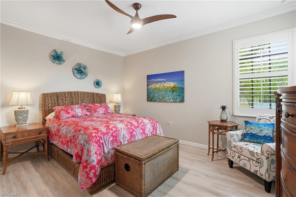 10505 Casella Way, Unit 202 Fort Myers, FL 33913 - Photo 38 of 50 a bedroom with a bed and wooden floor