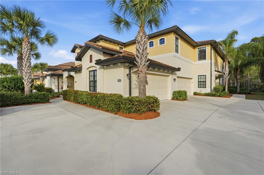 10505 Casella Way, Unit 202 Fort Myers, FL 33913 - Photo 5 of 50 a front view of a house with a yard