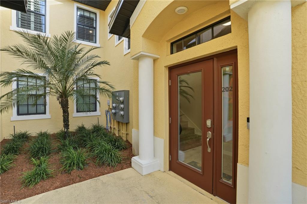 10505 Casella Way, Unit 202 Fort Myers, FL 33913 - Photo 7 of 50 a front view of a house with a glass door