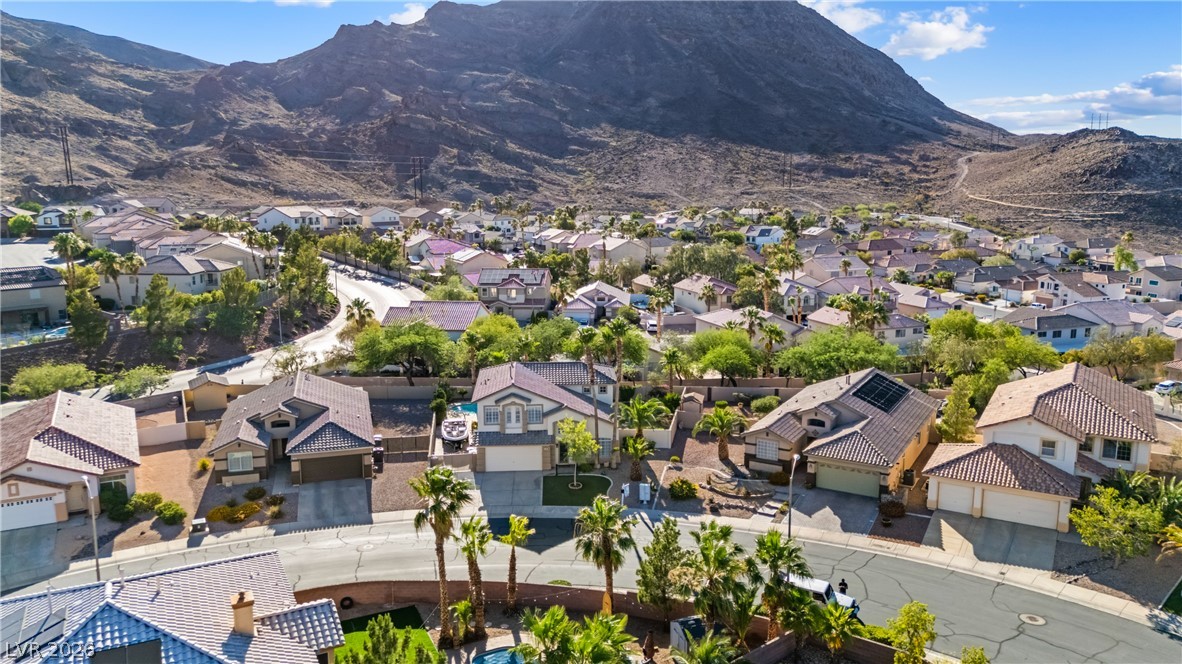 708 Vortex Avenue Henderson, NV 89002 - Photo 55 of 71 An aerial perspective reveals a vibrant neighborhood nestled against majestic mountains.
