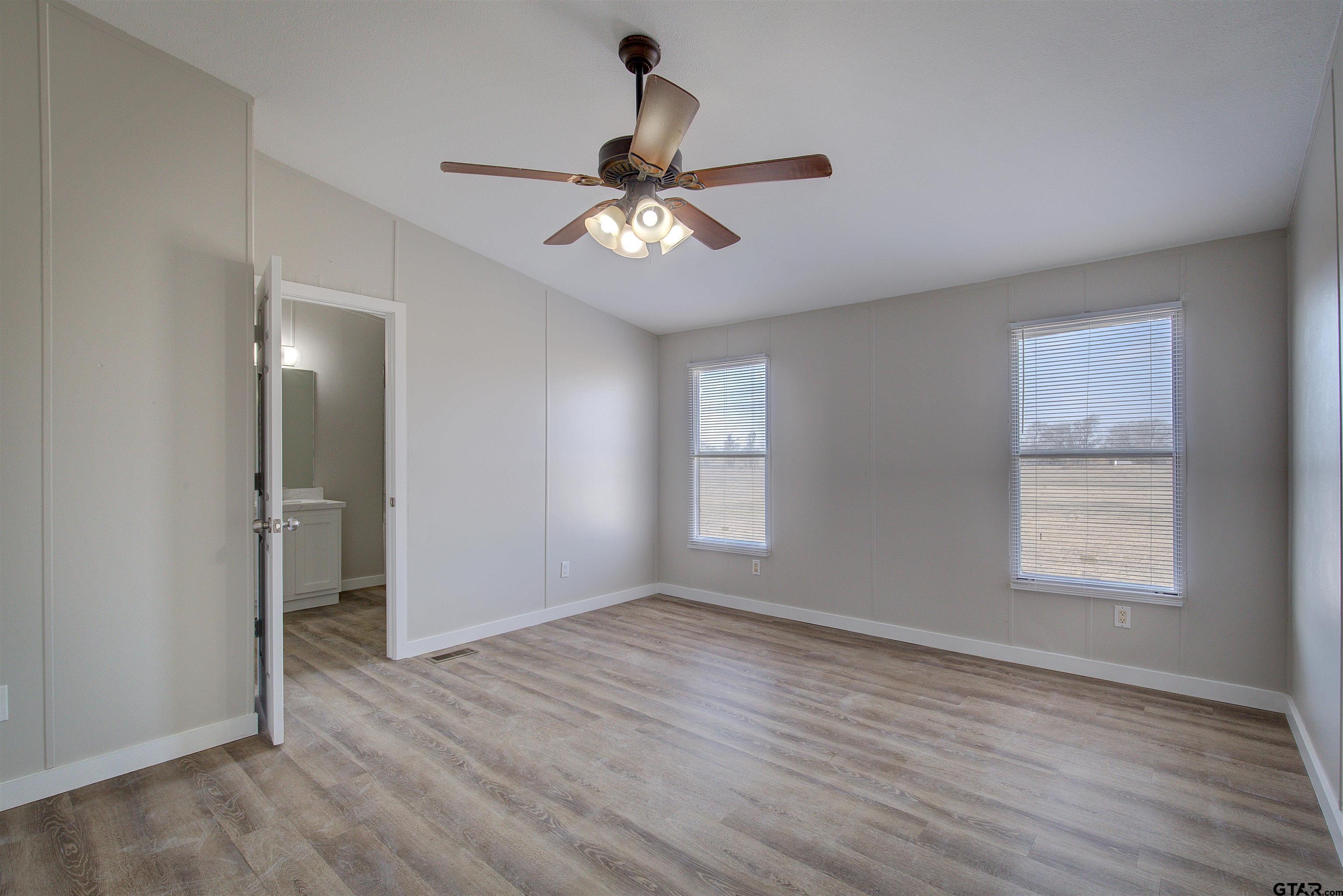 1945 Co Road Sulphur Springs, TX 75482 - Photo 13 of 29 wooden floor in an empty room with a window