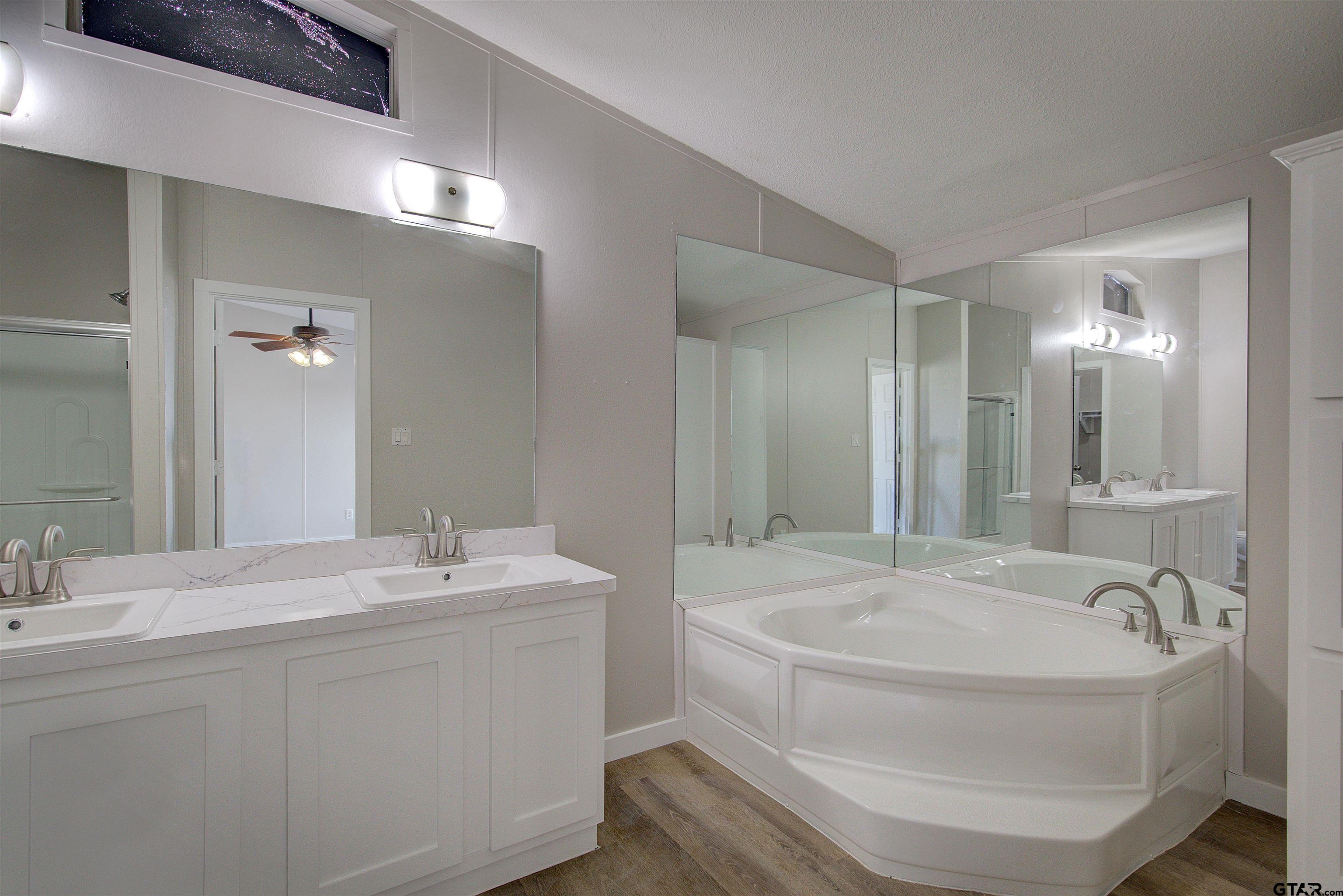 1945 Co Road Sulphur Springs, TX 75482 - Photo 14 of 29 a bathroom with a bathtub and a sink