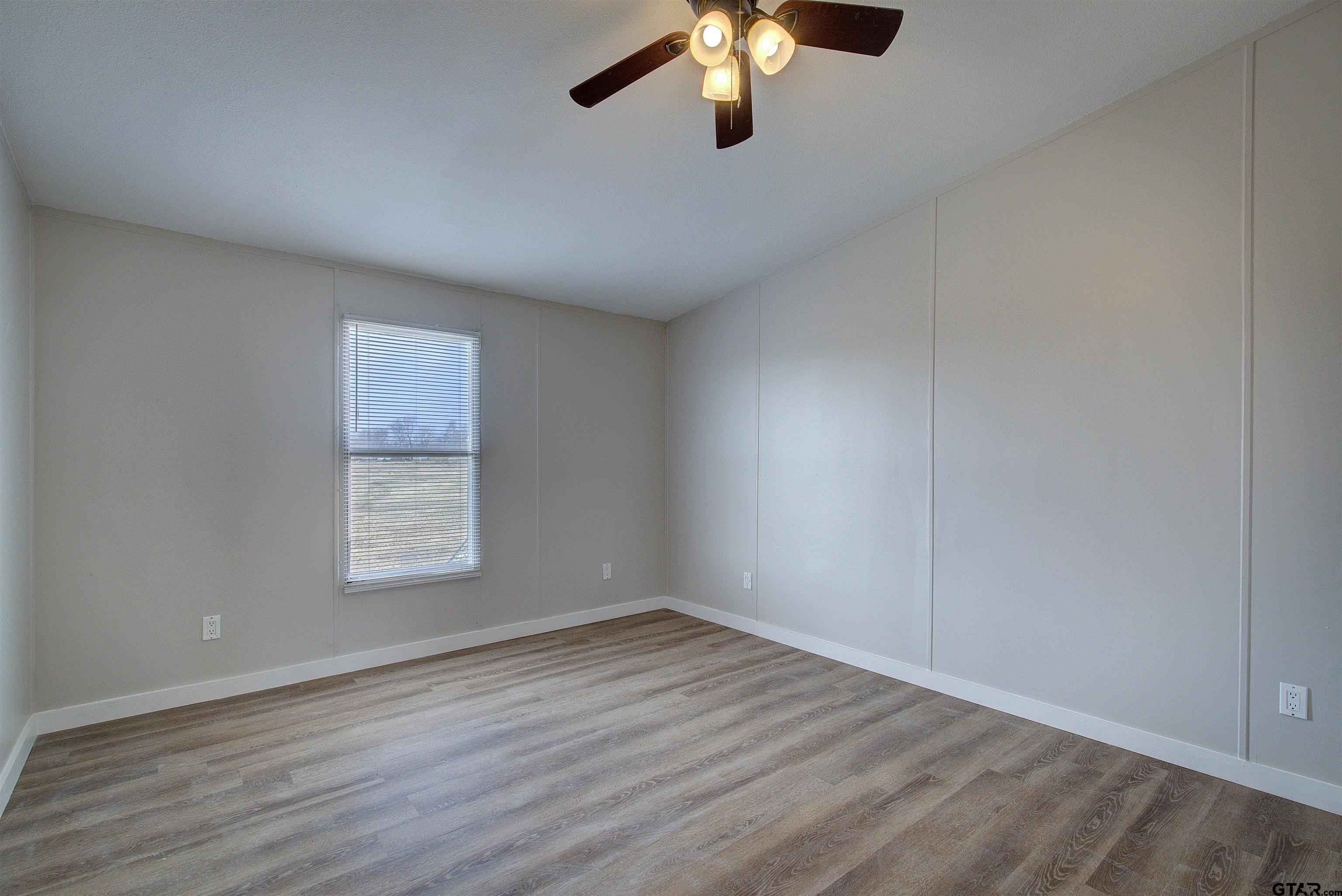 1945 Co Road Sulphur Springs, TX 75482 - Photo 19 of 29 wooden floor in an empty room with a window
