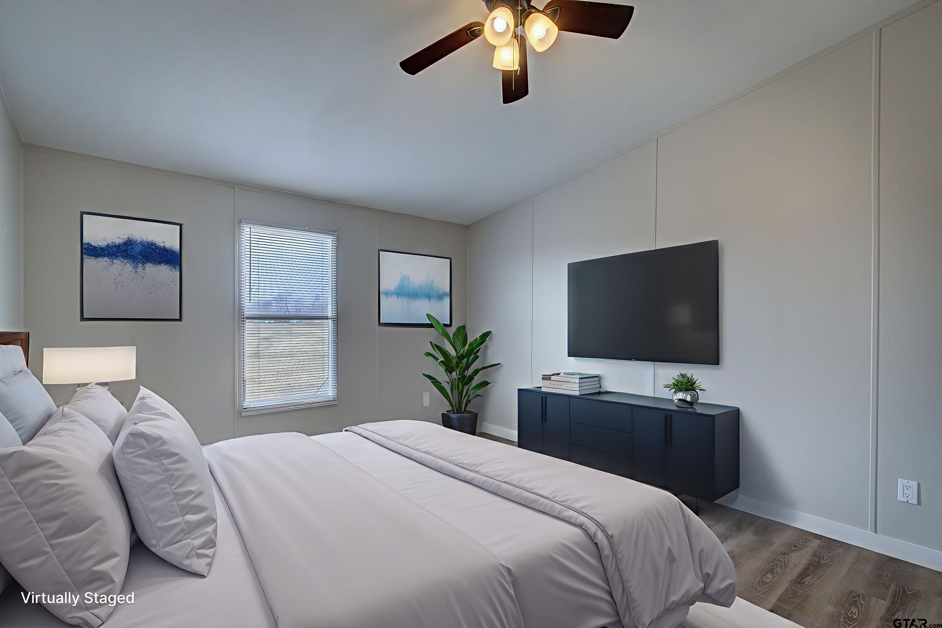 1945 Co Road Sulphur Springs, TX 75482 - Photo 20 of 29 a bedroom with a bed and a flat screen tv