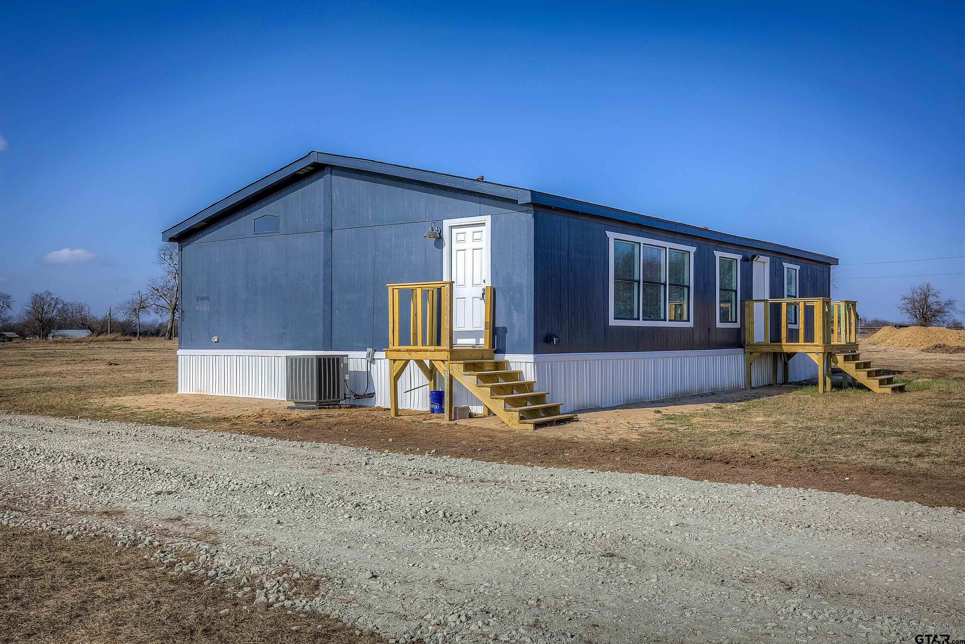 1945 Co Road Sulphur Springs, TX 75482 - Photo 2 of 29 a view of a house with backyard
