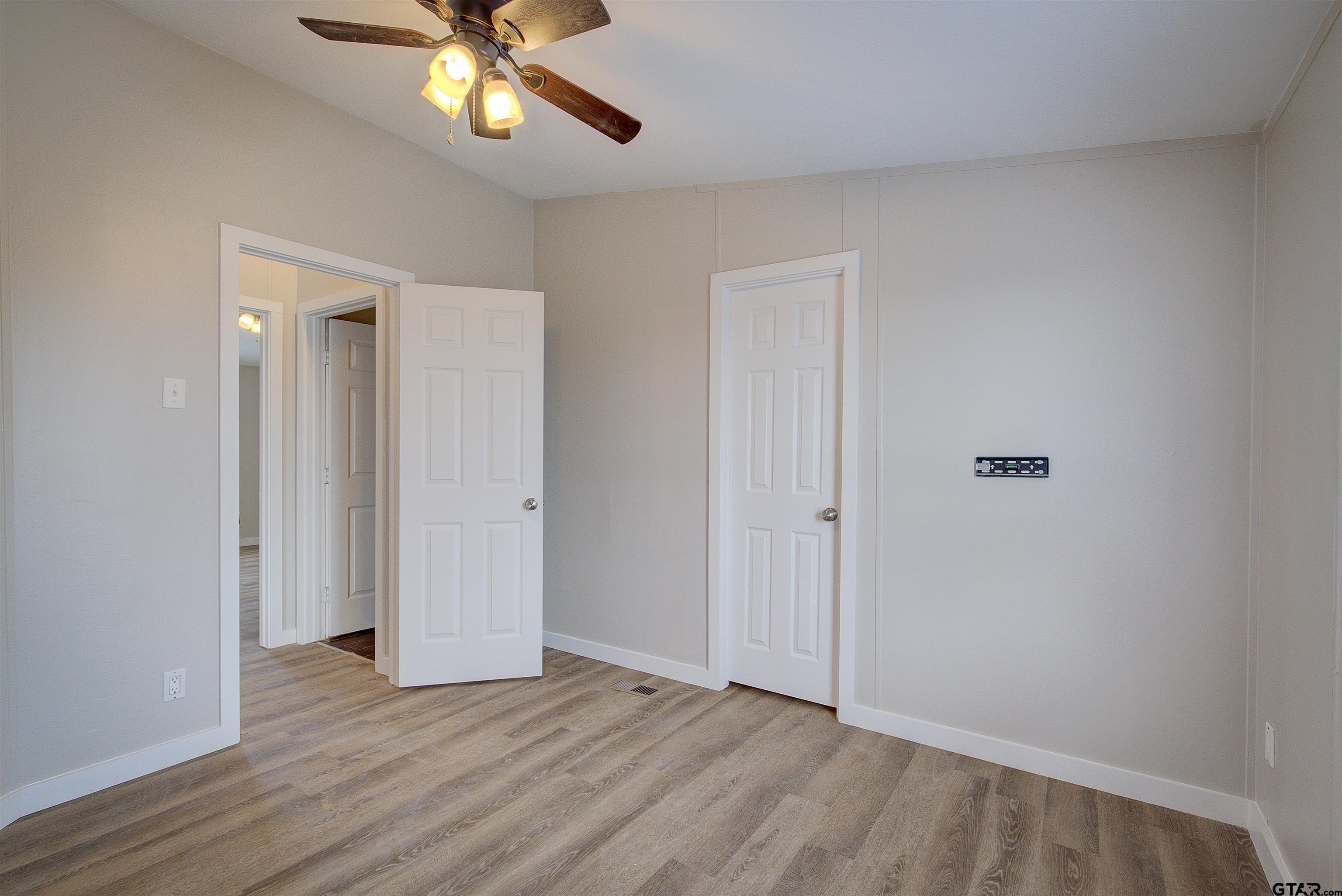 1945 Co Road Sulphur Springs, TX 75482 - Photo 22 of 29 a view of an empty room with window and wooden floor