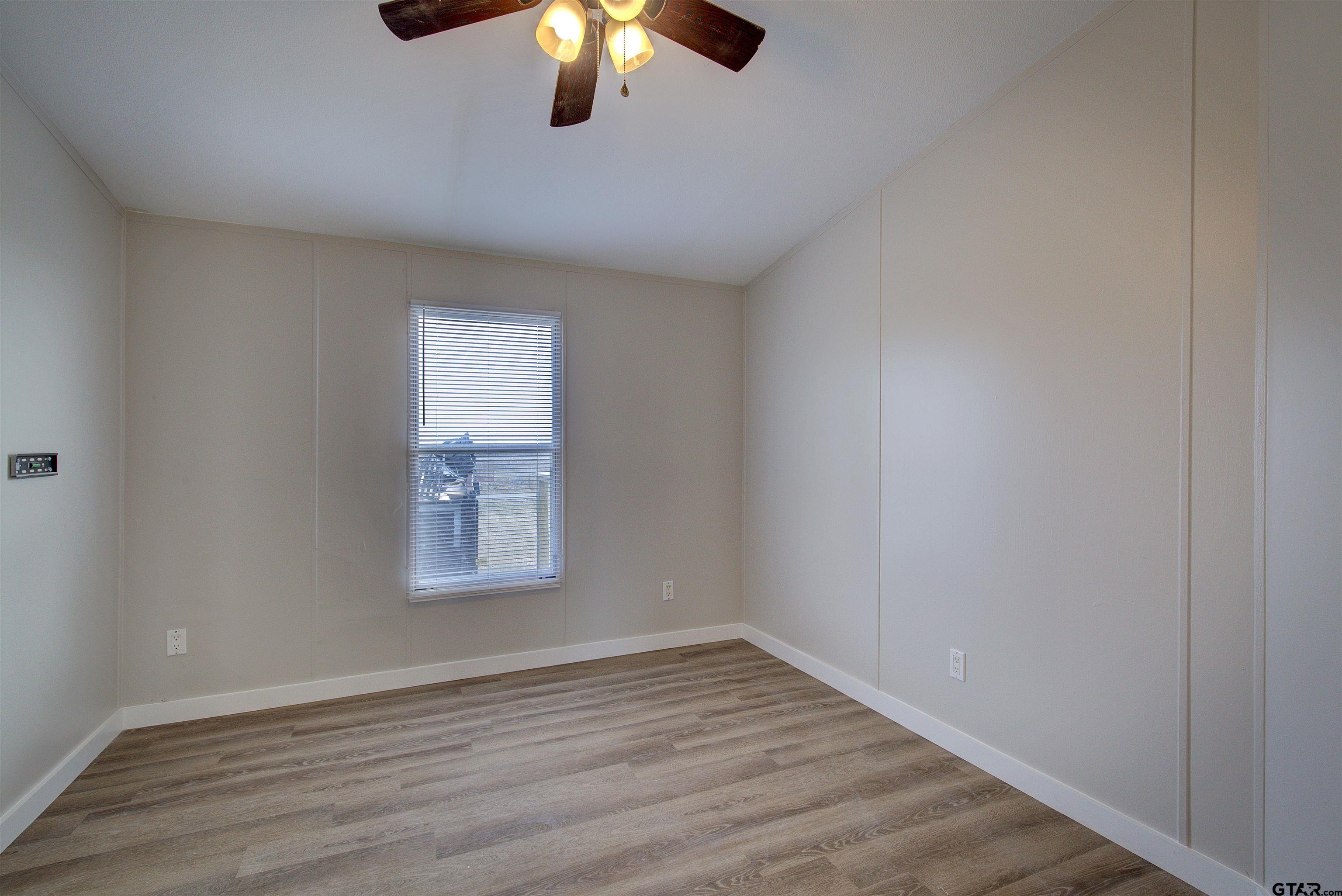 1945 Co Road Sulphur Springs, TX 75482 - Photo 24 of 29 wooden floor in an empty room with a window