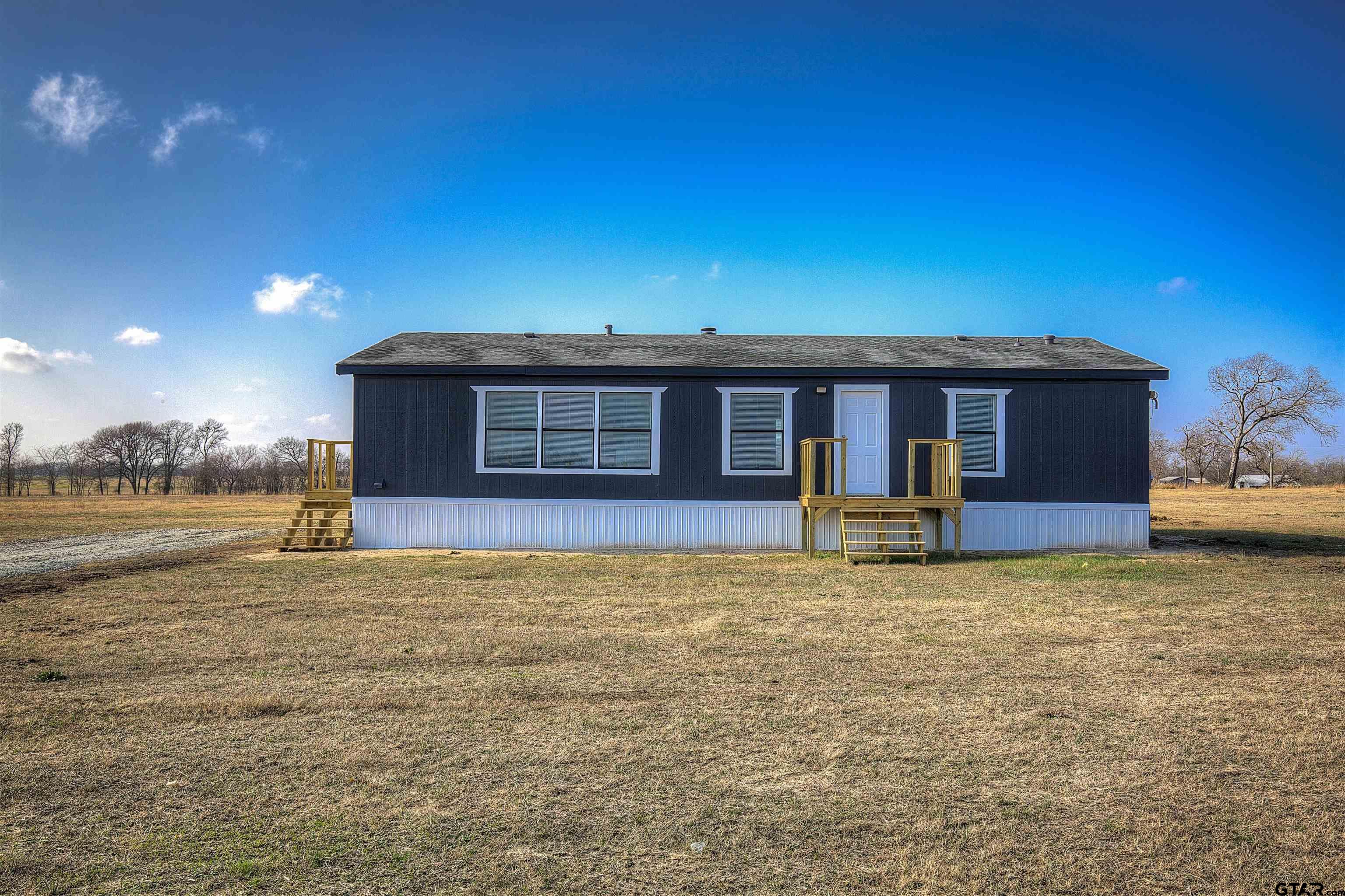 1945 Co Road Sulphur Springs, TX 75482 - Photo 26 of 29 a view of a house with backyard porch and sitting area