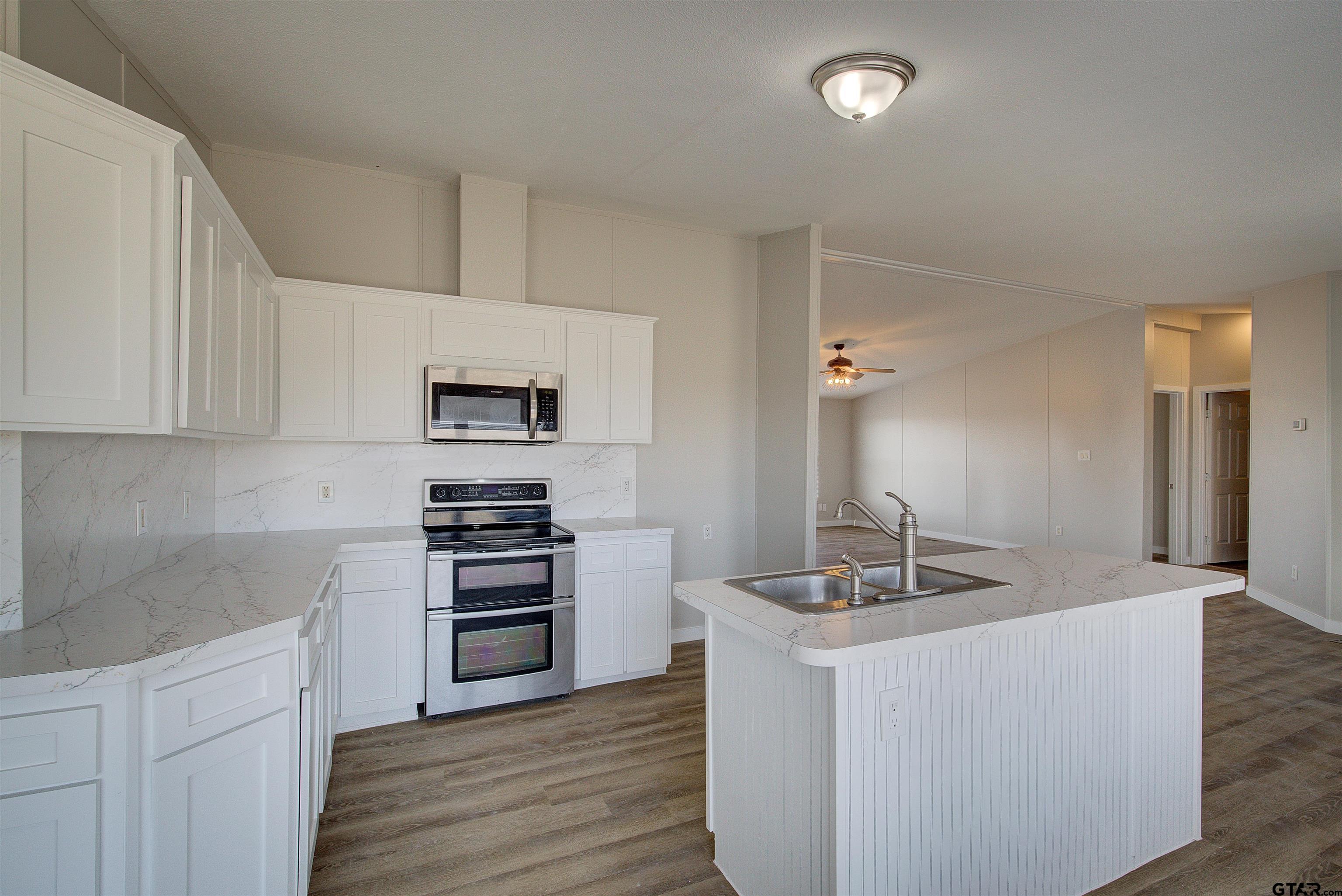 1945 Co Road Sulphur Springs, TX 75482 - Photo 8 of 29 a kitchen with sink cabinets and stainless steel appliances