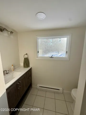 a bathroom with a sink a toilet and a mirror