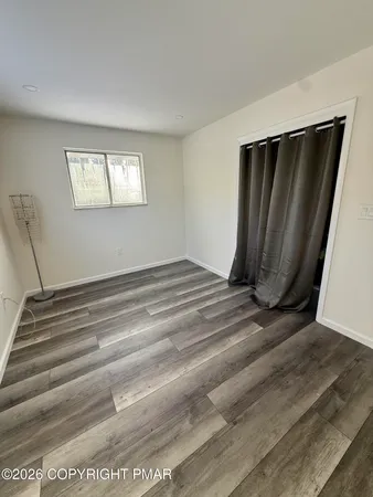a view of a closet area with wooden floor